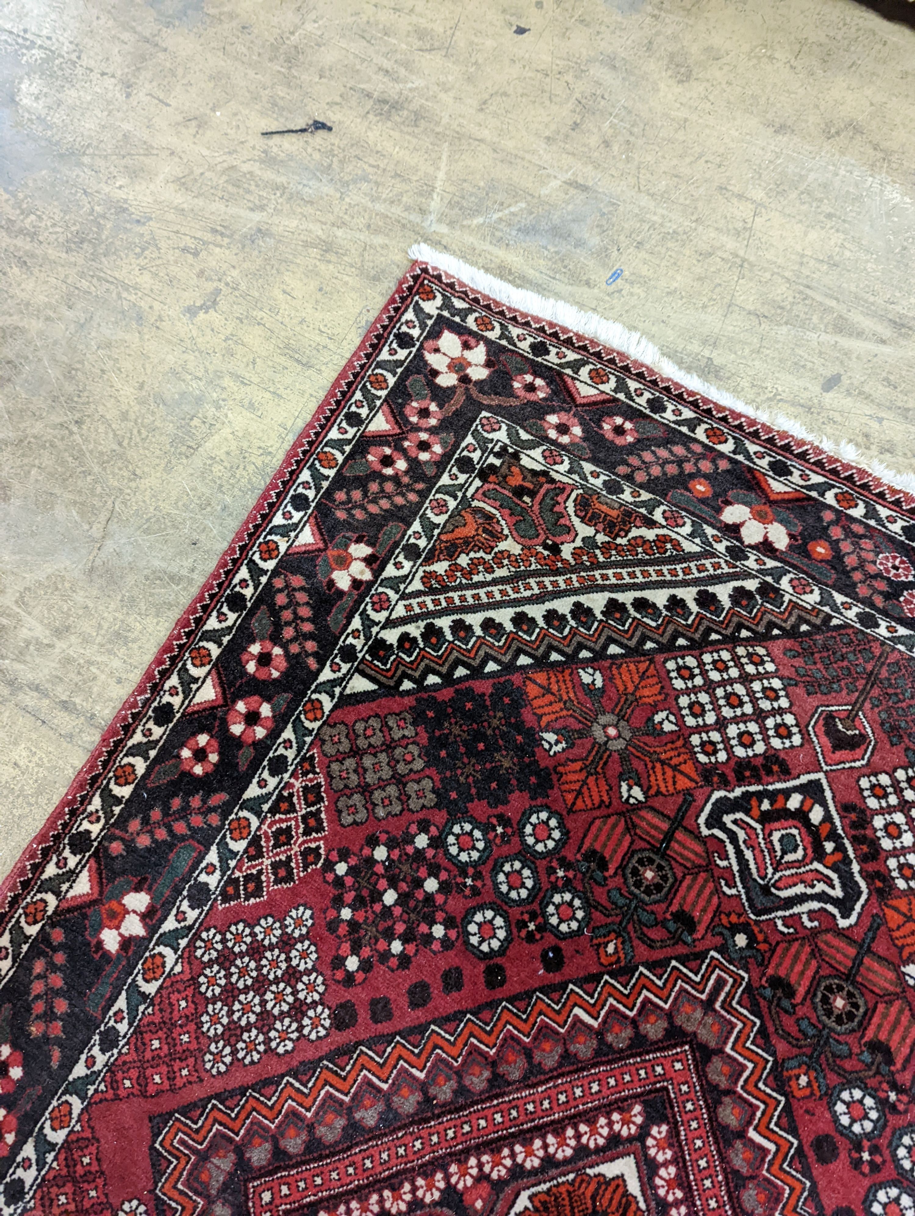 A North West Persian red ground rug, 200 x 130cm